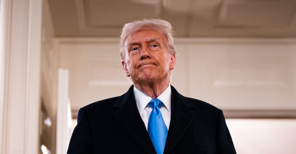 President Donald Trump stands inside the White House.