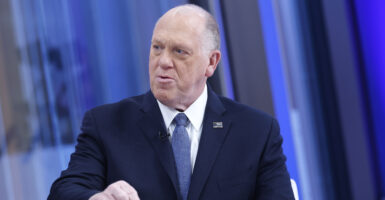 Tom Homan wears a navy suit and blue necktie.