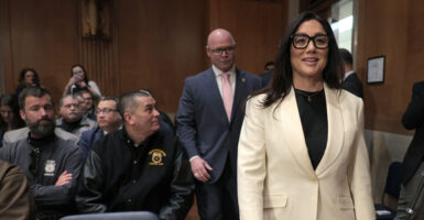 Lori Chavez-Deremer enters the Senate committee hearing room accompanied by Teamsters President Sean O'Brien.
