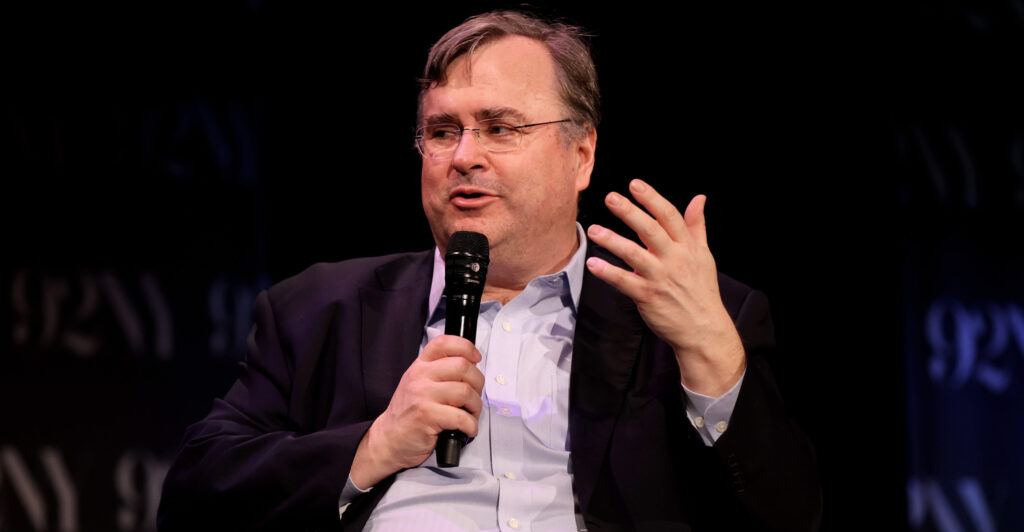 Tech billionaire Reid Hoffman holding a microphone