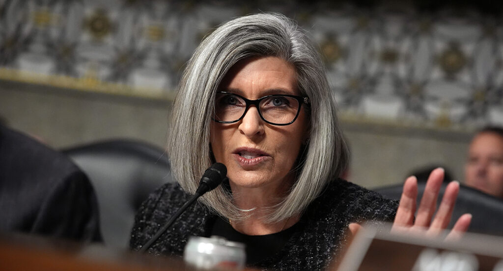 Joni Ernst gestures in a congressional hearing
