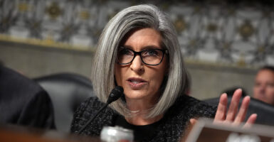 Joni Ernst gestures in a congressional hearing