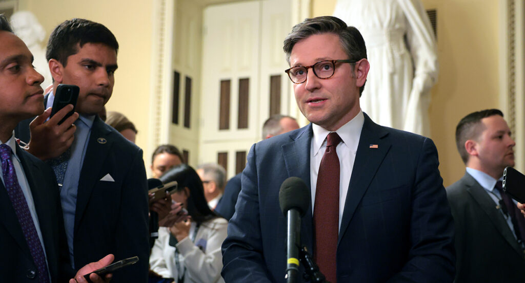 Mike Johnson in a suit with a red tie