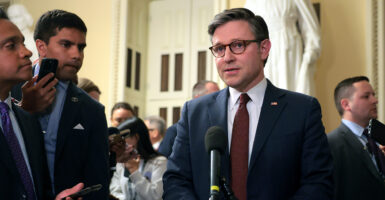 Mike Johnson in a suit with a red tie