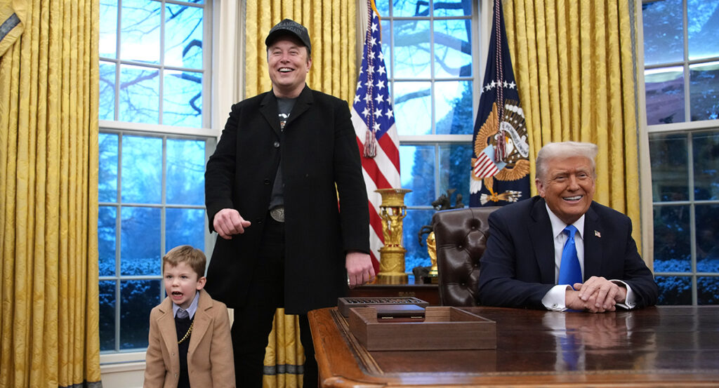 Elon Musk and his son stand in the Oval Office with President Donald Trump