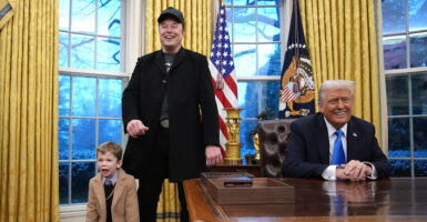 Elon Musk and his son stand in the Oval Office with President Donald Trump