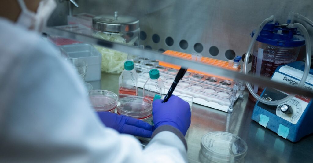 A lab technician writes down results from a test in a laboratory.