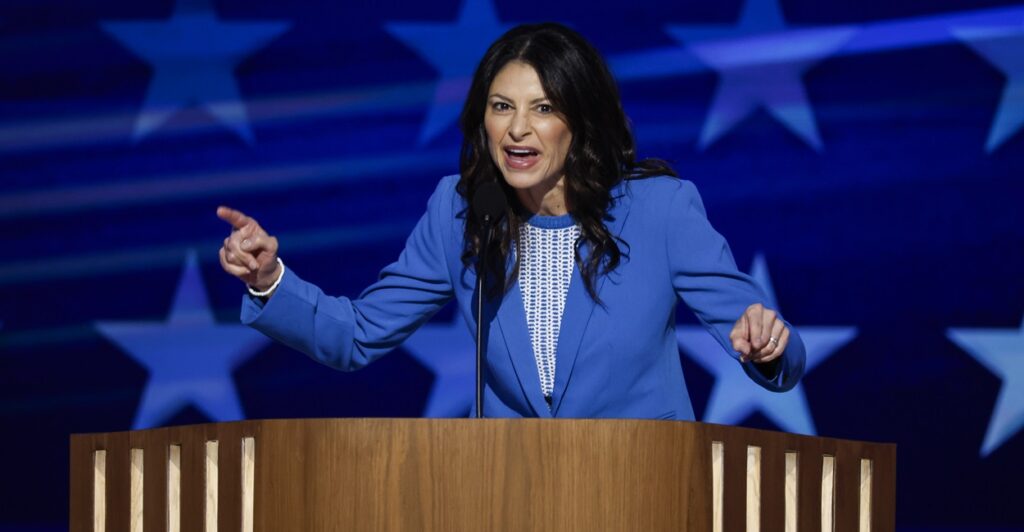 Dana Nessel is giving a speech and pointing her finger in an animated gesture.