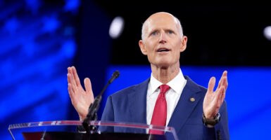 Rick Scott in a blue suit with a red tie