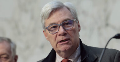Sheldon Whitehouse in a suit and glasses