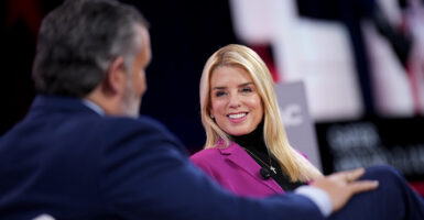 Pam Bondi smiles at Ted Cruz