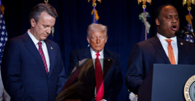 Donald Trump prays between Reps. Ben Cline and Jonathan Jackson