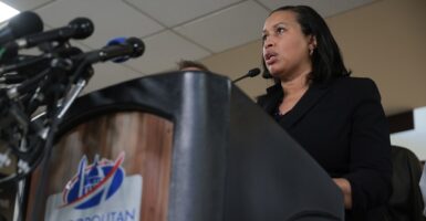 Muriel Bowser stands at a podium and speaks as she looks out in front of her.