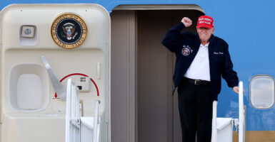 President Donald Trump gestures as he departs Air Force One.
