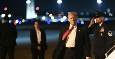 President Donald Trump steps off Air Force One as he arrives at Palm Beach International Airport in West Palm Beach, Florida, on Friday night.