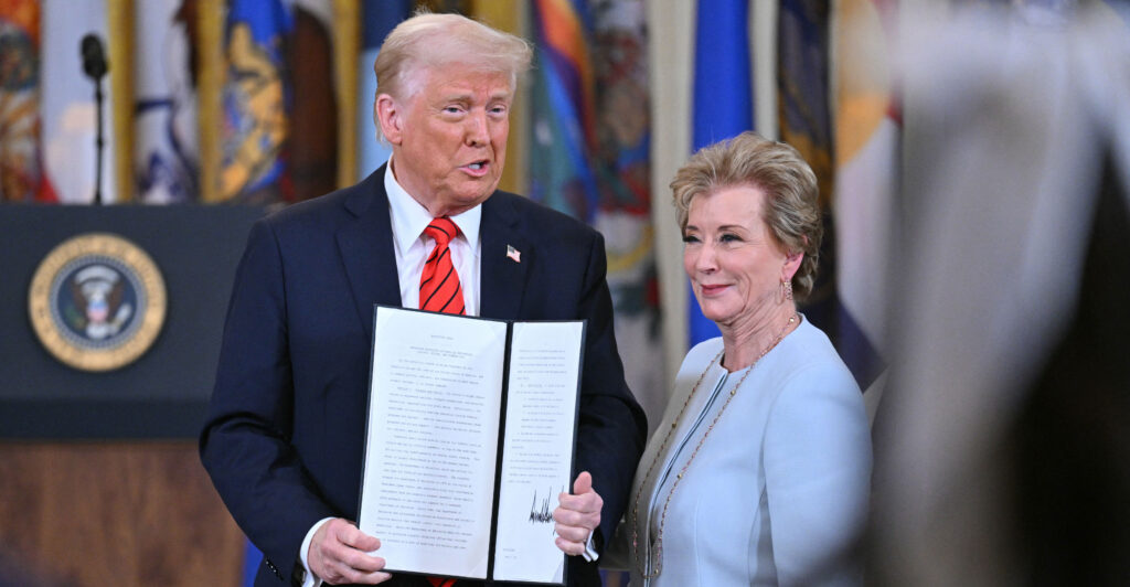 President Donald Trump holds an executive order after signing it, alongside Secretary of Education Linda McMahon, at the White House on Thursday.