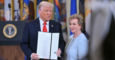 President Donald Trump holds an executive order after signing it, alongside Secretary of Education Linda McMahon, at the White House on Thursday.