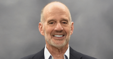 Barry Strauss poses for a portrait and smiles.