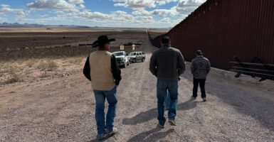 Rancher Russell Johnson walks with friends on his ranch in Luna County, New Mexico, along the border with Mexico, on March 12.