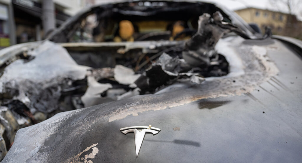 A burned out tesla with the Tesla symbol visible