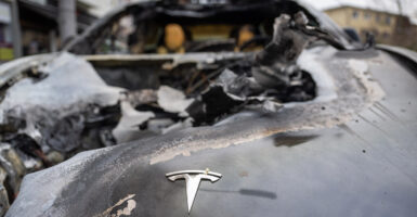 A burned out tesla with the Tesla symbol visible