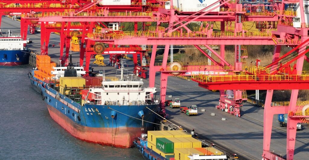 Containers sit on a big tanker in a port in China.