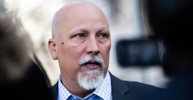 Chip Roy in a grey suit with a blue-checkered shirt