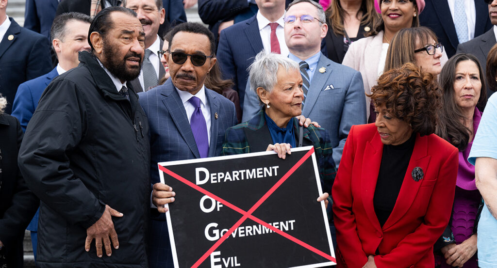 House Democrats stand with a sign reading "Department of Government Evil."
