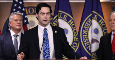 Rep. Brandon Gill, R-Texas, with a backdrop of U.S. and House of Representatives flags