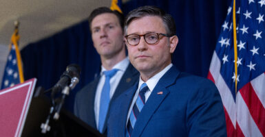 House Speaker Mike Johnson, R-La., with an unidentified fellow House Republican colleague