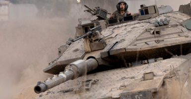 An Israeli tank rolls near the border with the Gaza Strip in southern Israel on Dec. 11.