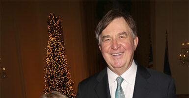 James Piereson wears a black suit and blue tie at a gala.