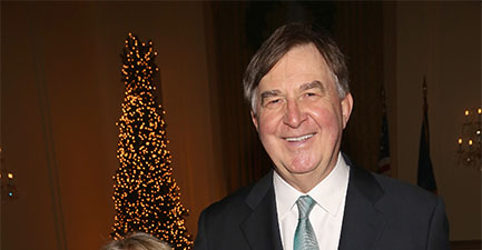 James Piereson wears a black suit and blue tie at a gala.