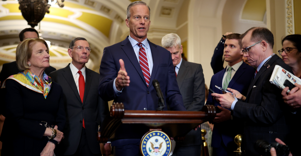 Backed by fellow Senate Republicans, Majority Leader John Thune, R-S.D., speaks to reporters.
