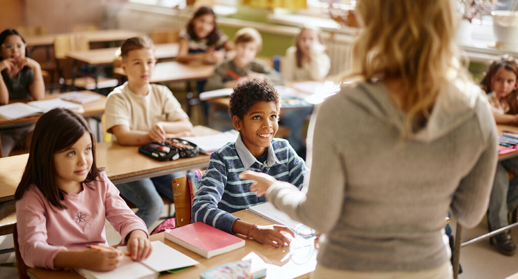 Kids in a classroom paying close attention to the teacher