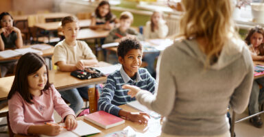 Kids in a classroom paying close attention to the teacher