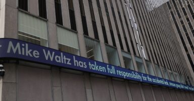 A Fox News ticker tape shows a headline about the leak in a group chat involving the Trump administration.