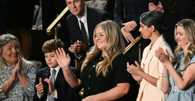 Payton McNabb in a black dress waves