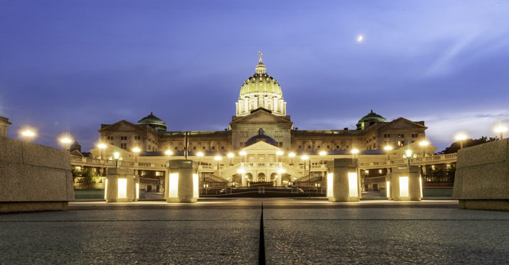 The Pennsylvania state capital is lit up at dusk.