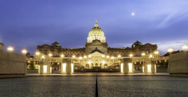 The Pennsylvania state capital is lit up at dusk.
