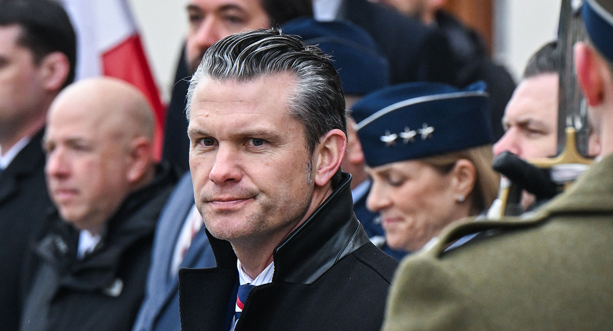Pete Hegseth with military members behind him