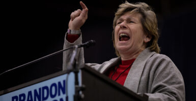 Randi Weingarten shouts behind a podium