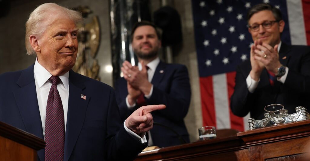 Donald Trump turns and points during his address to Congress.