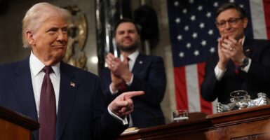 Donald Trump turns and points during his address to Congress.