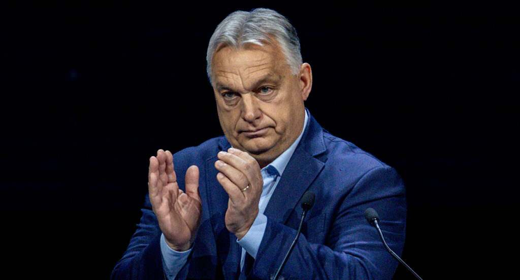 Viktor Orban claps in a blue suit
