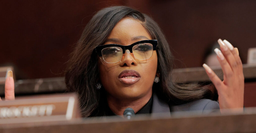 Representative Jasmine Crockett holds up her hands as she speaks at a House hearing