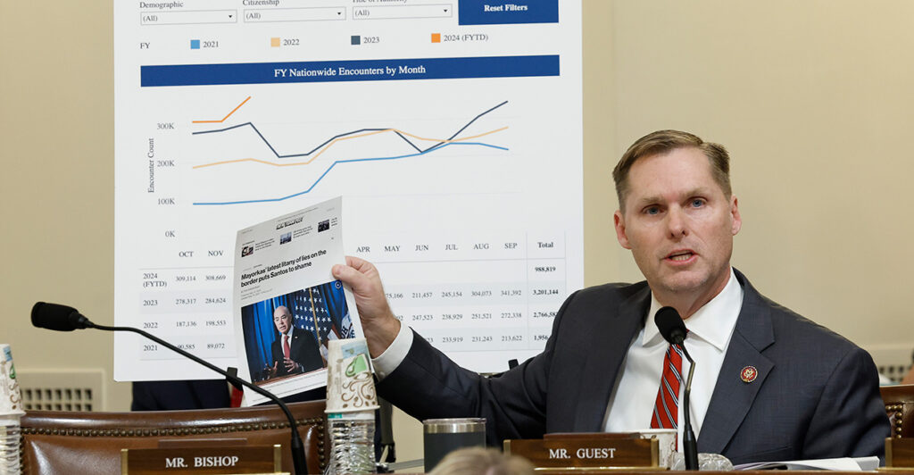With a giant chart behind him documenting illegal immigration statistics, Rep. Michael Guest, R-Miss., speaks at a hearing of the House Committee on Homeland Security on Jan. 30, 2024.