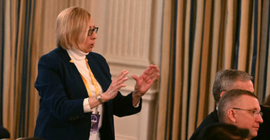 Maine Gov. Janet Mills, a Democrat, speaks with President Donald Trump at a National Governors Association event at the White House on Feb. 21.