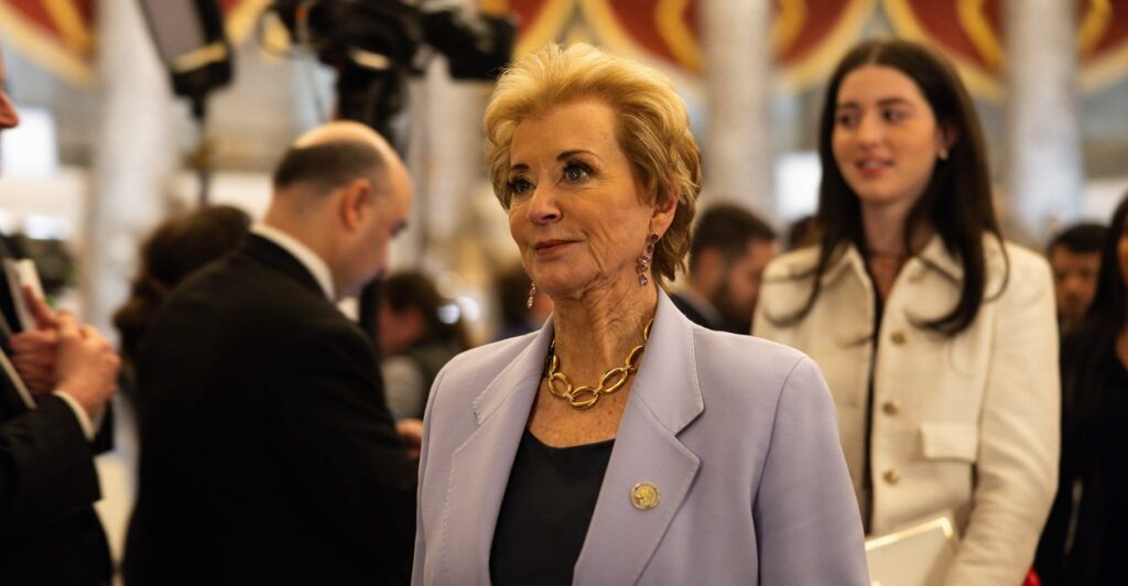 Linda McMahon stands and looks straight ahead.