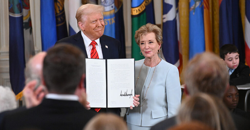President Donald Trump and Education Secretary Linda McMahon hold up an executive order dismantling the Department of Education at the White House on March 20.